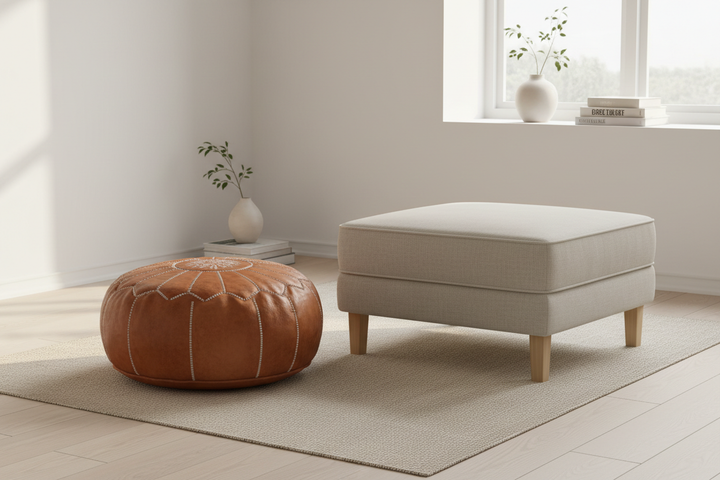 Moroccan leather pouf and structured ottoman side by side in a Scandinavian living room