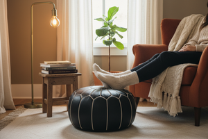 Black Moroccan leather pouf as footrest in reading nook