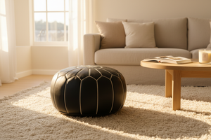 Black Moroccan leather pouf in cozy interior setting