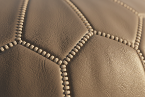 Close-up stitching detail of grey Moroccan leather pouf
