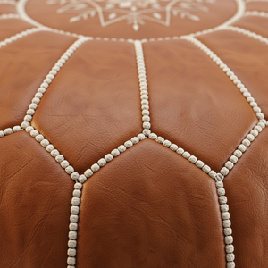 Close-up stitching detail of Moroccan leather pouf