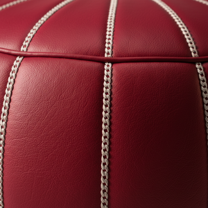 Close-up stitching detail of red Moroccan leather pouf