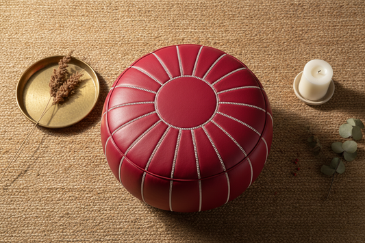 Flat lay of red Moroccan leather pouf