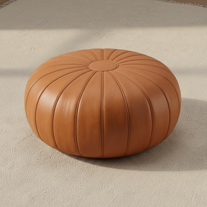 Flat lay of tan leather pouf