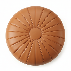 Top-down close-up of tan leather pouf